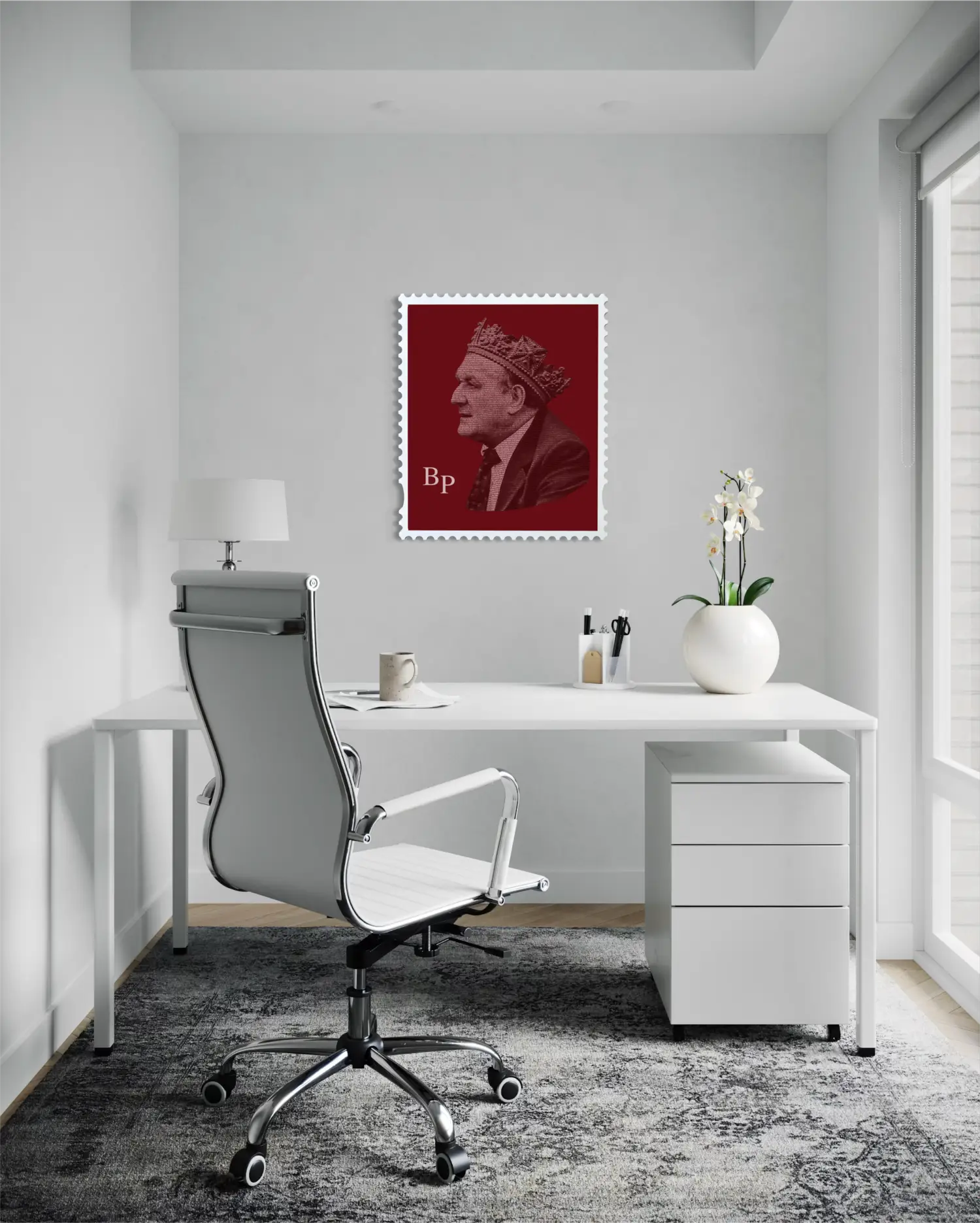 Bob Paisley typography stamp portrait hanging on a light grey wall in a bright modern home office, above a white desk with an ergonomic chair, a small table lamp, and a white orchid – demonstrating the artwork as an understated yet striking statement piece in a contemporary workspace. #size_large