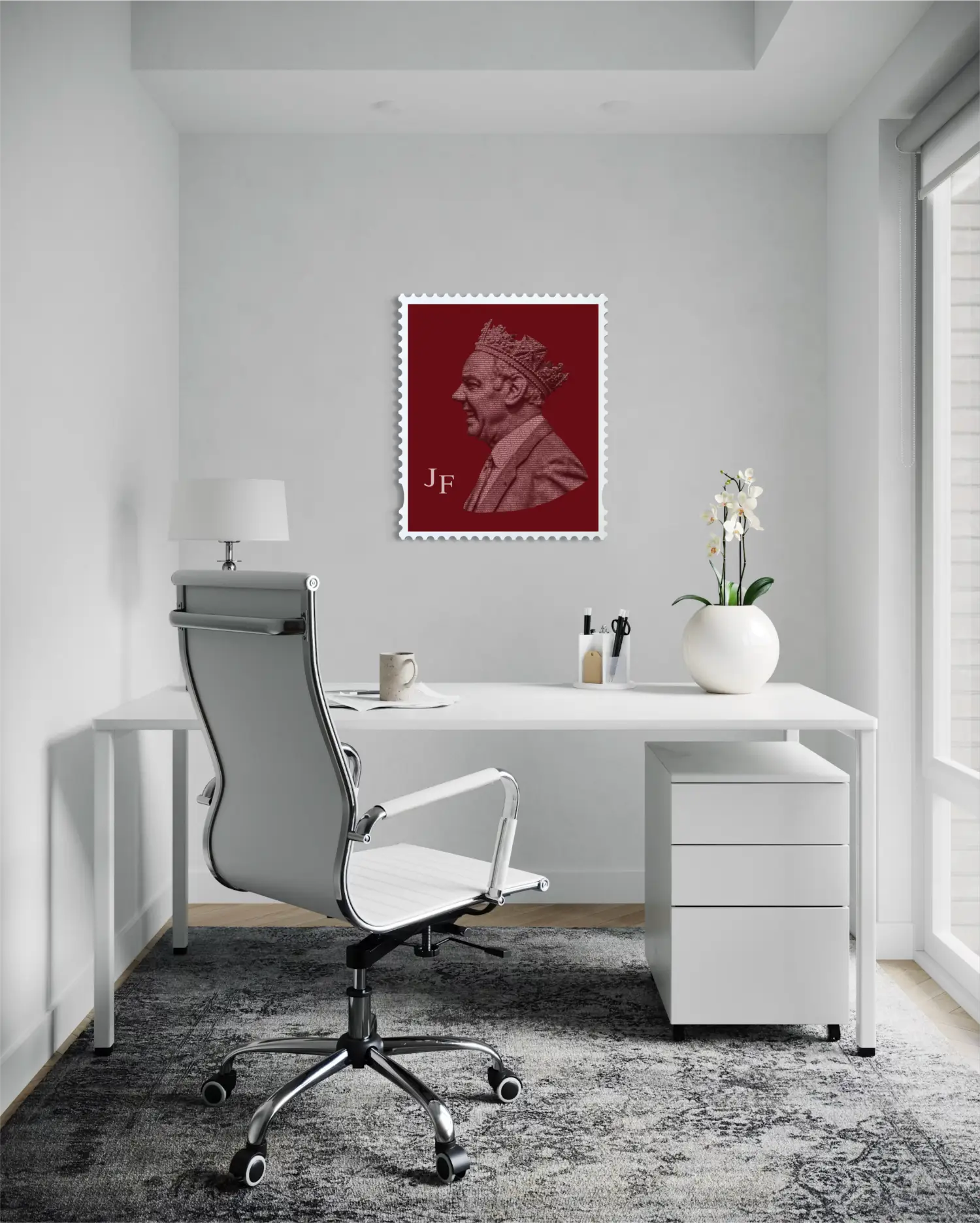 Joe Fagan typography stamp portrait hanging on a light grey wall in a bright modern home office, above a white desk with an ergonomic chair, a small table lamp, and a white orchid – demonstrating the artwork as an understated yet striking statement piece. #size-large