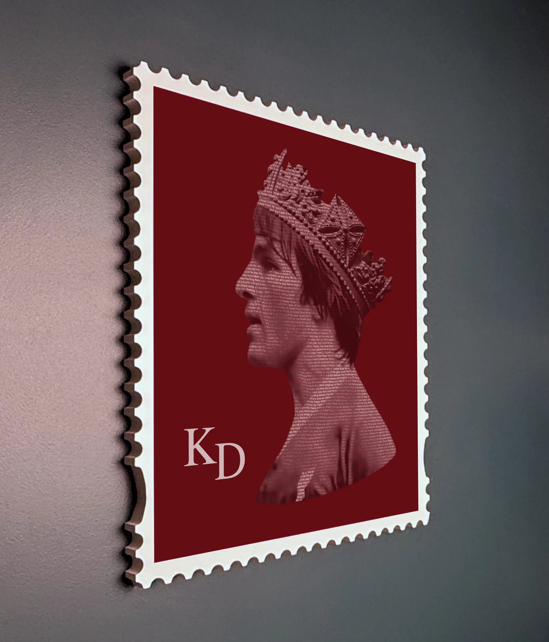 Framed Kenny Dalglish stamp artwork shown from side angle in white wooden frame highlighting depth and premium aluminium print finish