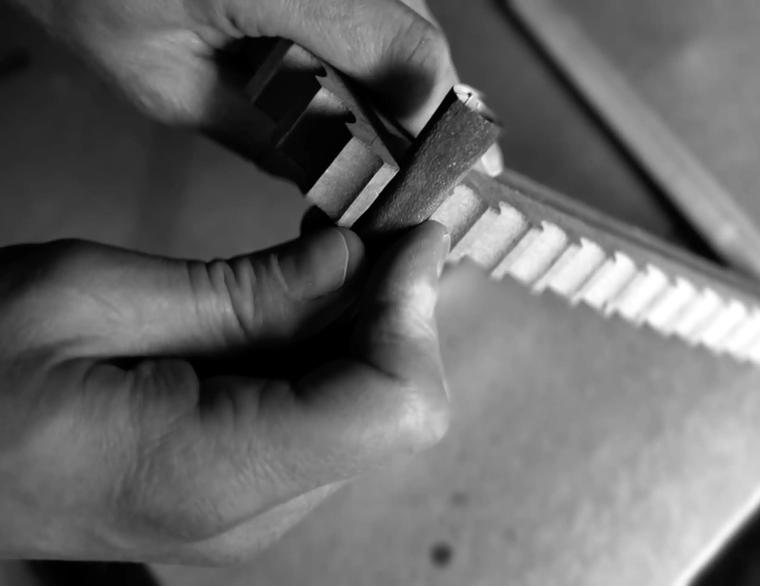 Hand-sanding a handcrafted wooden stamp frame during production, highlighting the craftsmanship behind each True Royalty artwork
