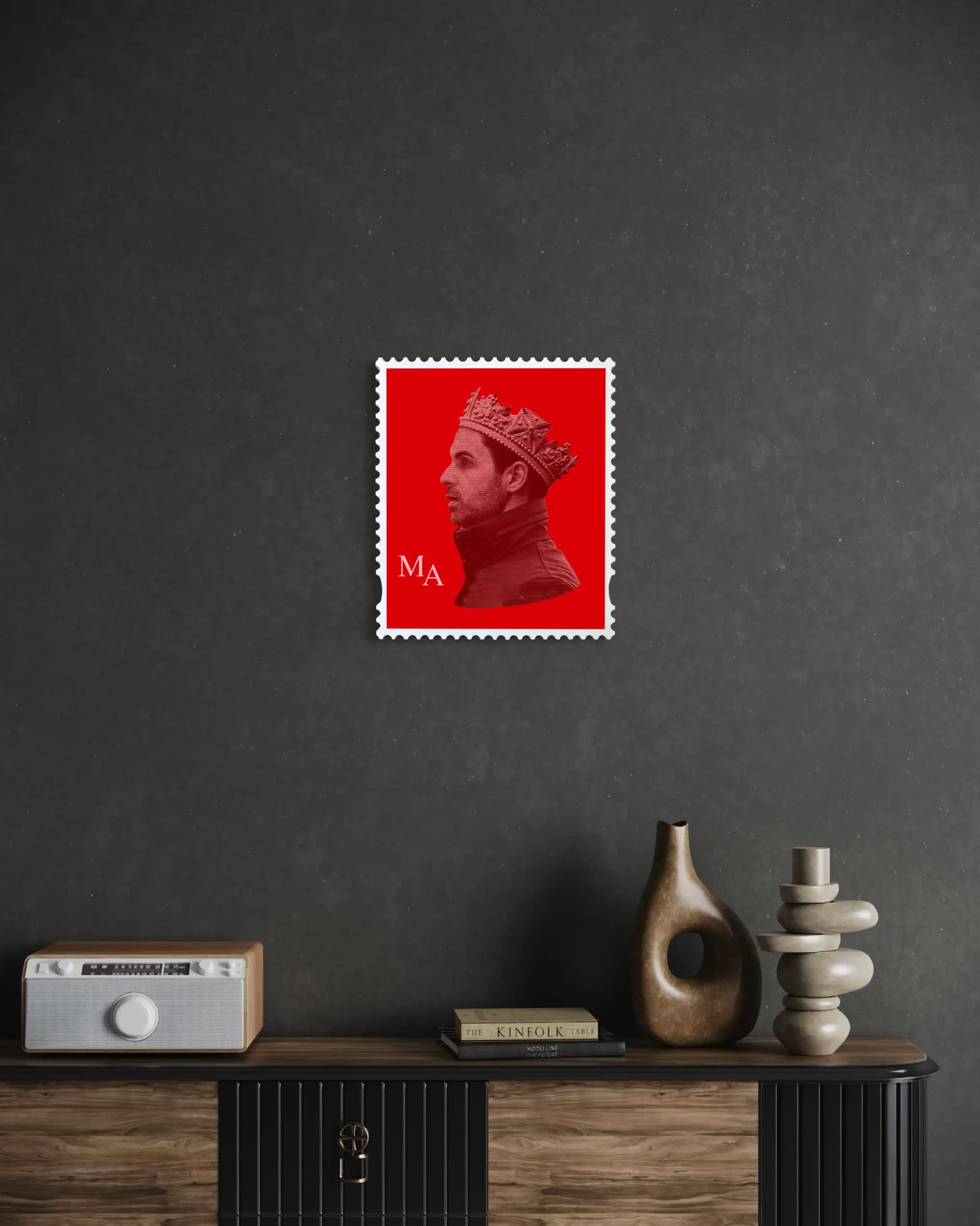 Mikel Arteta limited edition stamp artwork displayed on dark grey wall above a wooden sideboard cabinet in a moody luxury interior setting. #size_medium