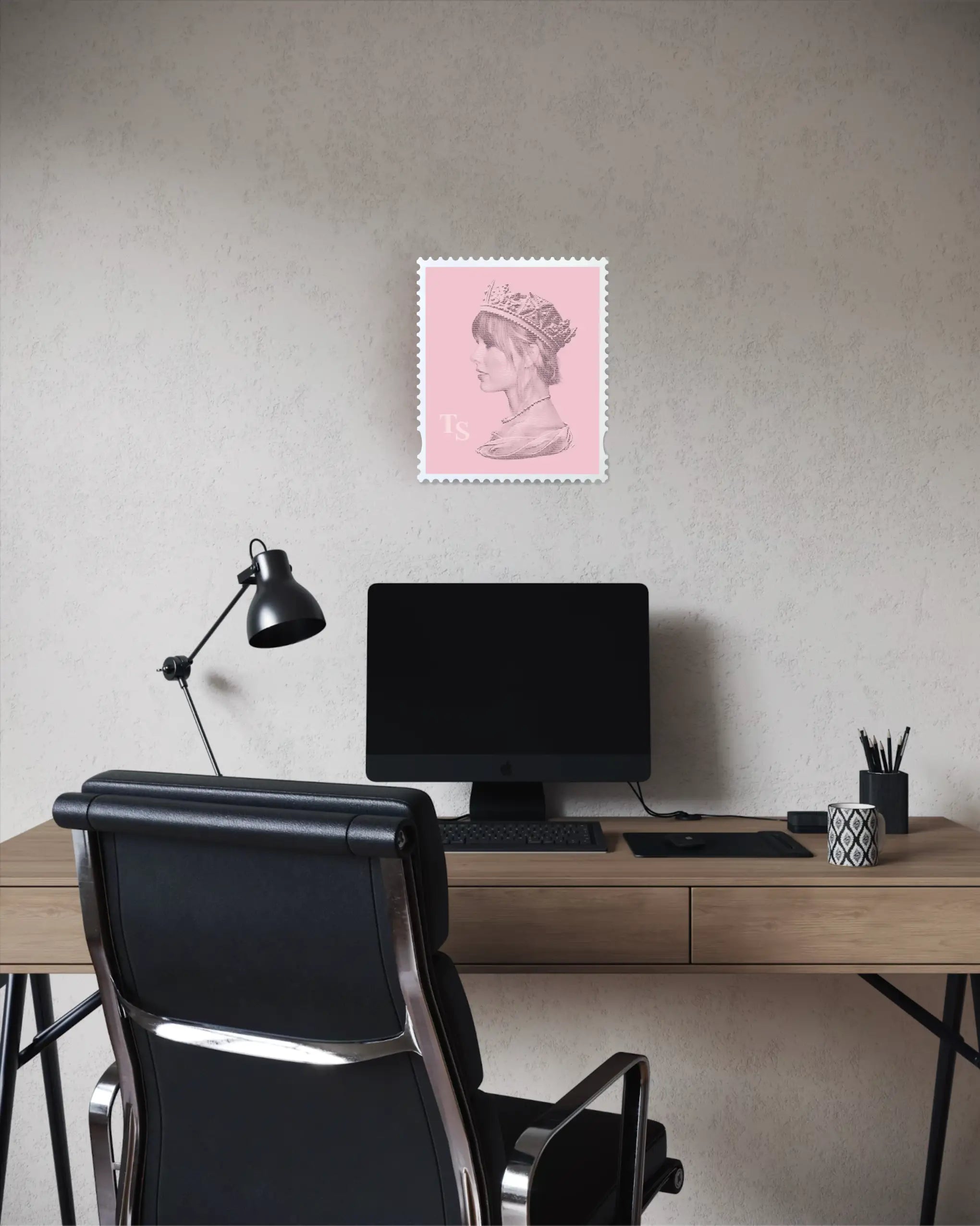 Taylor Swift Long Live the Queen stamp art print displayed above a desk in a contemporary home office, pink artwork against a textured neutral wall above an iMac and black office chair. #size_medium